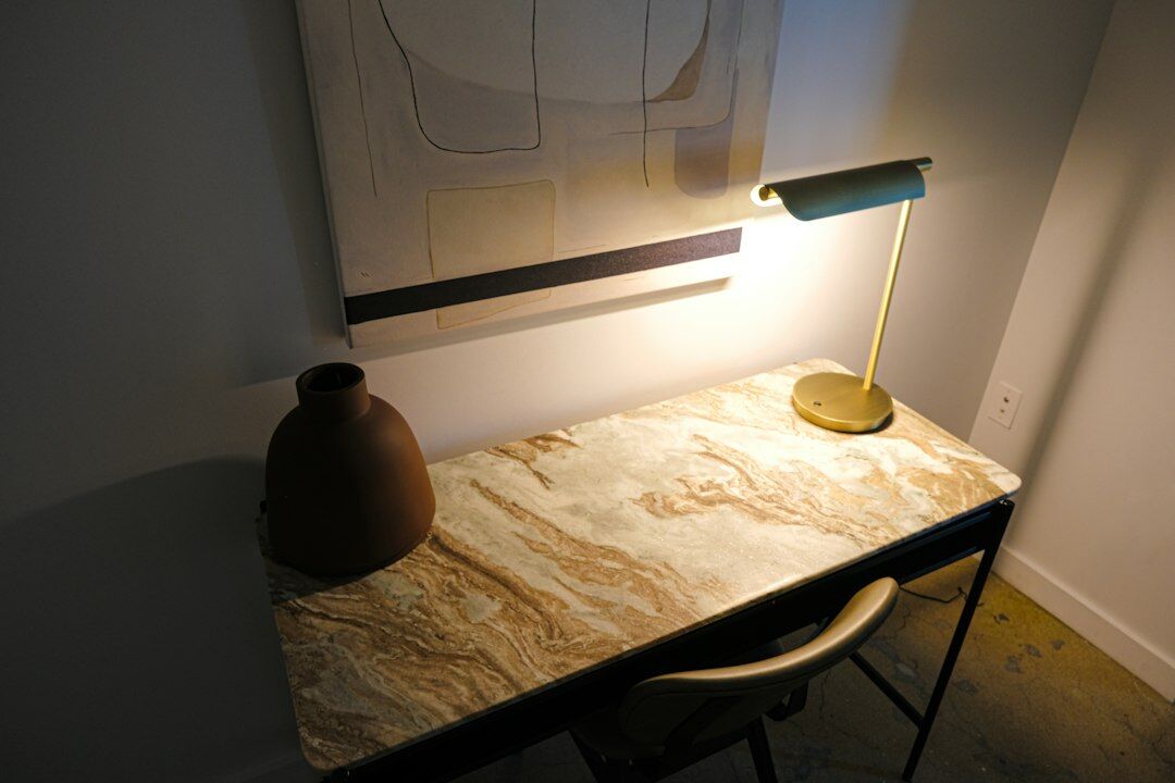 Minimalist quiet writing desk with lamp and notebook